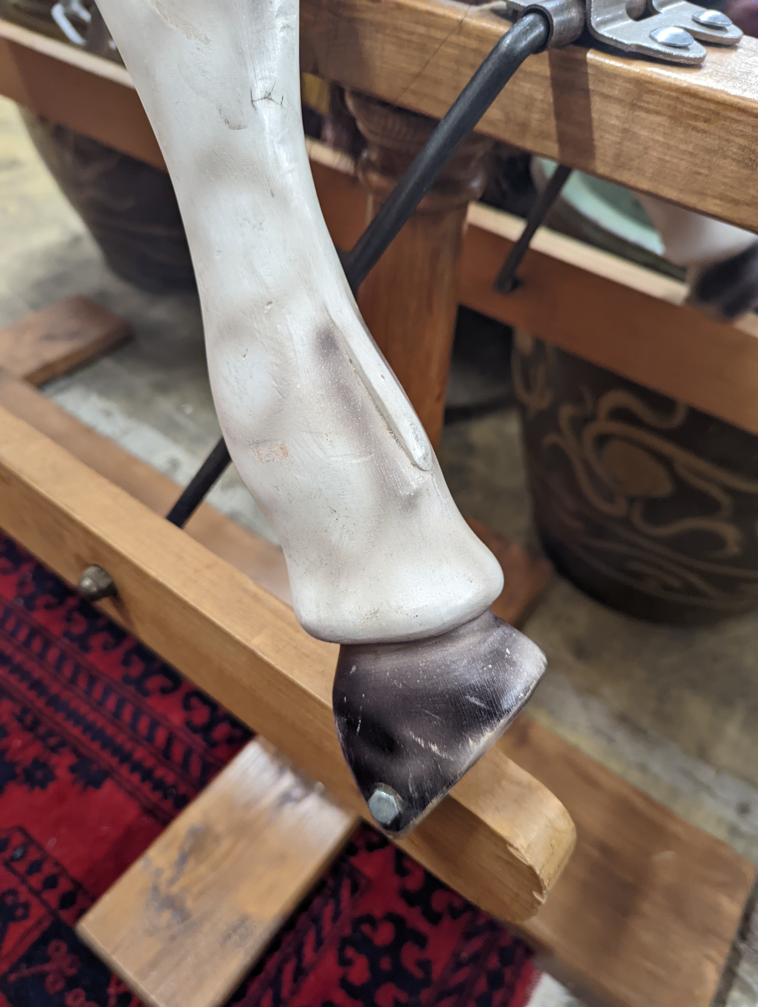 A Victorian style dapple grey rocking horse on pine stand, length 152cm, height 126cm